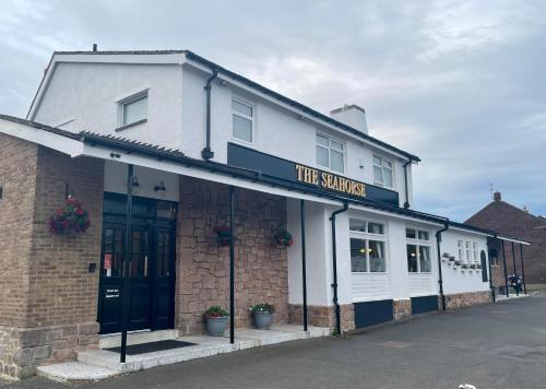 a white building with a sign that reads the sakuraarma at The seahorse in Blythe
