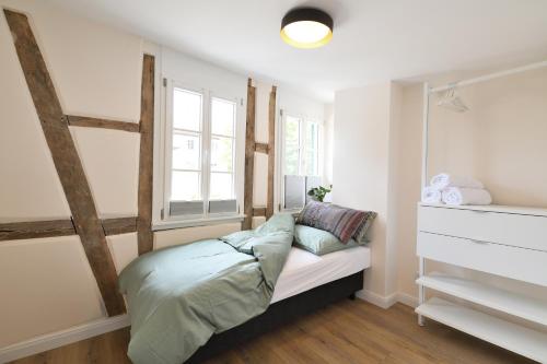 Postel nebo postele na pokoji v ubytování Das schiefe Haus- Wohnung "Nibelungen"