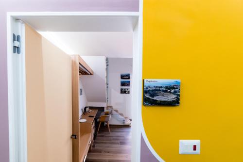a hallway with a yellow wall in a room at Centro Storico in Pozzuoli