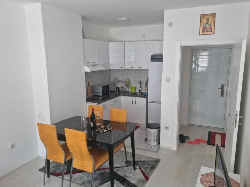 a kitchen with a table and chairs in a room at Apartman Miloš in Soko Banja