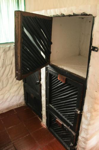 an open door to a room with a stove at Praba Hostel in Palomino