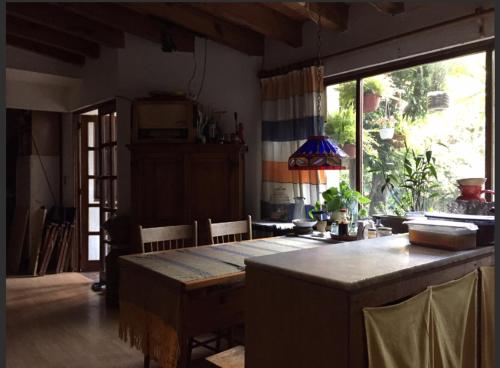 a dining room with a table and a large window at Cuarto baño sala San Angel cerca de ITAM UNAM Bazar Sábado in Mexico City