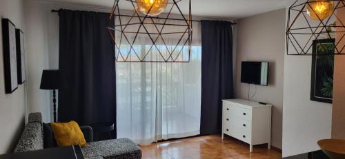 a living room with a couch and a window at Albatros Tenerife Golf Sea View in San Miguel de Abona