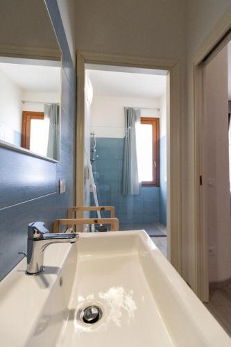 a bathroom with a white sink and a mirror at Il Glicine in Marsala