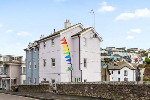 a building with a colorful kite on the side of it at A modern and cosy apartment just yards from Brixham’s bustling harbourside in Brixham