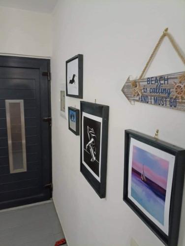 a hallway with pictures on the wall and a door at Angel's Houses in Skala Kallonis