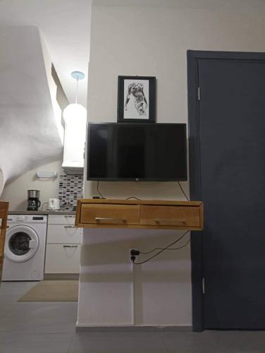 a television on a table in a kitchen at Angel's Houses in Skala Kallonis