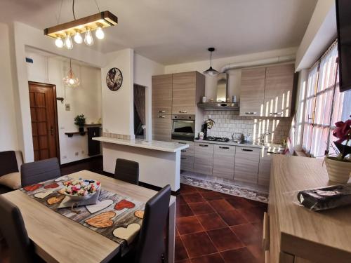 a kitchen with a table with a bowl of food on it at Una finestra sul verde in Sassello