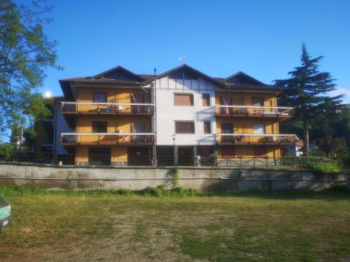 an apartment building with balconies and a yard at Una finestra sul verde in Sassello