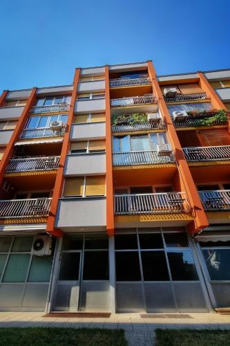 an orange building with balconies on it at Apartma Vrtnica 5th floor in Nova Gorica
