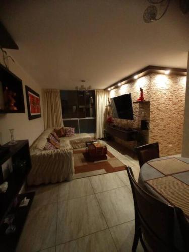 a living room with a couch and a television at Dpto entero, 2do piso, ascensor y cochera in Lima