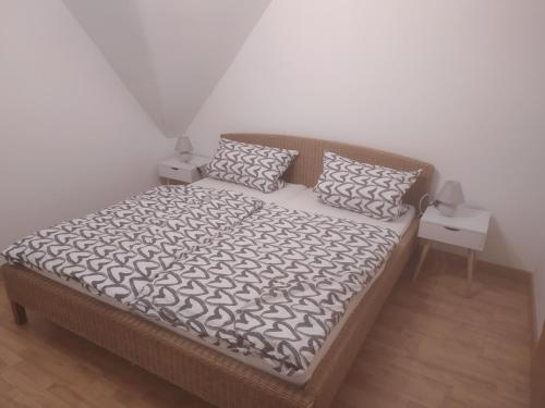 a bed in a room with two pillows on it at FeWo Apfelbaum in Saarbrücken
