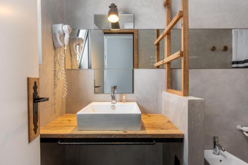 a bathroom with a white sink and a mirror at Apartamentos Marvela in Lagos