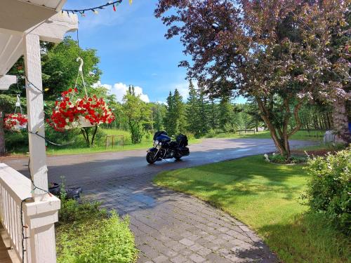 a person riding a motorcycle down a road at Green Village in Calgary