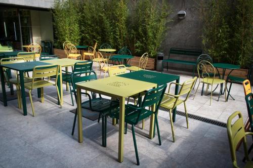 a row of tables with chairs and tables with umbrellas at Alberg Pere Tarrés in Barcelona