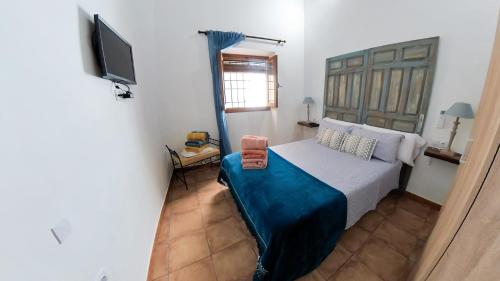 1 dormitorio con 1 cama y TV en Apartamento Santa Leocadia, en Toledo