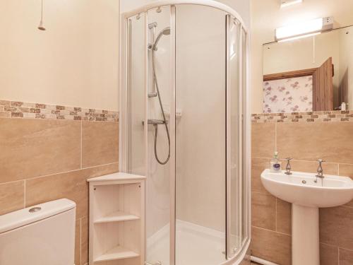 a bathroom with a shower and a sink at Punch Cottage in Little Glenham