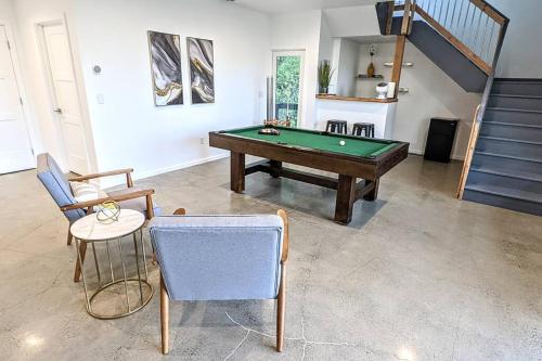 a living room with a pool table and chairs at Modern 4BR Loft- Denali View, Roofdeck, Pool Table in Eagle River
