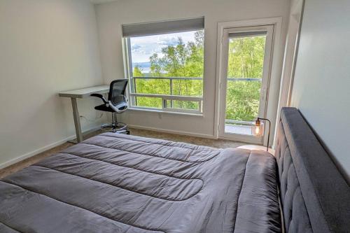 a bedroom with a bed and a desk and a window at Modern 4BR Loft- Denali View, Roofdeck, Pool Table in Eagle River