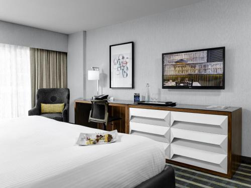 a hotel room with a bed and a desk at Hotel Arts in Calgary