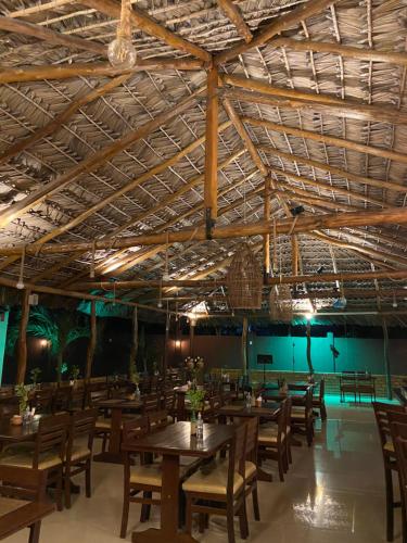 a dining room with wooden tables and chairs at Pousada Paraiso - Santo Amaro Centro - perto de tudo in Santo Amaro