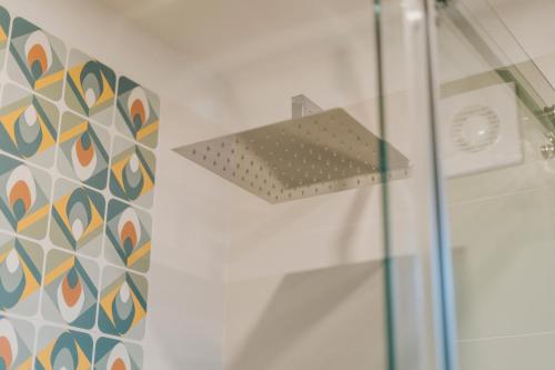 a shower stall with a shower head in a bathroom at Mimì Room in Castellammare di Stabia