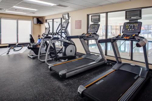 a gym with several treadmills and elliptical machines at TownePlace Suites by MarriottDetroit Canton in Canton