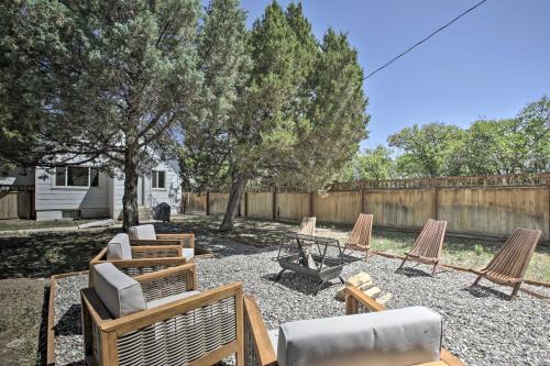 a backyard with chairs and tables and a fence at Beautiful Thermopolis Home with Private Yard and Grill in Thermopolis