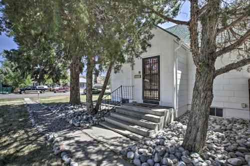 a white house with stairs and trees in front at Beautiful Thermopolis Home with Private Yard and Grill in Thermopolis