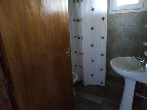 a bathroom with a sink and a door with stars on the wall at Deptos del sur in Tandil