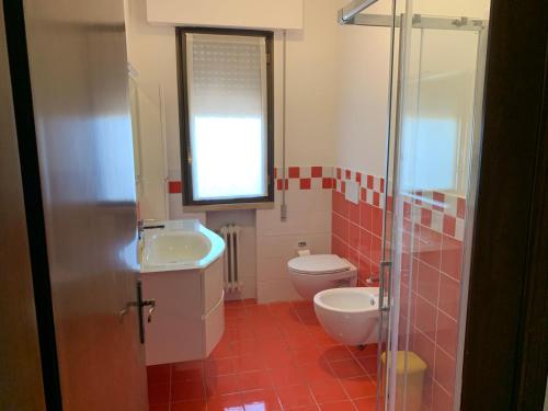 a bathroom with a toilet and a sink and a shower at Venice Day Apartment in Mestre