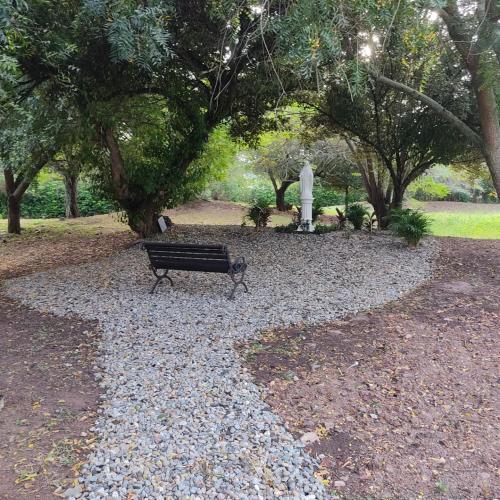 a park bench sitting in the middle of a park at Arizona Ranch Hotel in Girardot