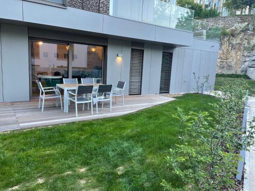 a patio with a table and chairs on a deck at Brand New Luxury 3 bedrooms, Terrace and Free Parking - noah in Luxembourg