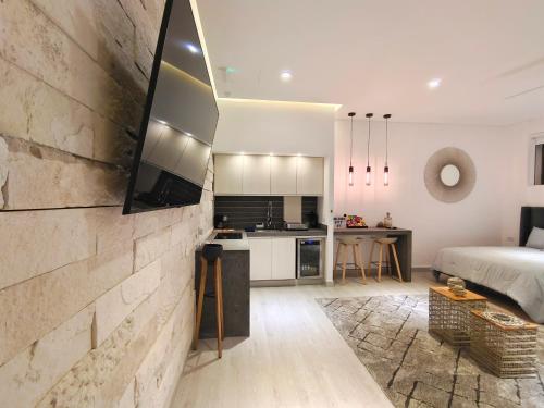 a living room with a bed and a kitchen at 1st Luxury Warehouse in Cancún