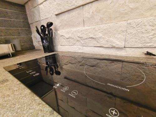 a counter with scissors in a vase on a wall at 1st Luxury Warehouse in Cancún