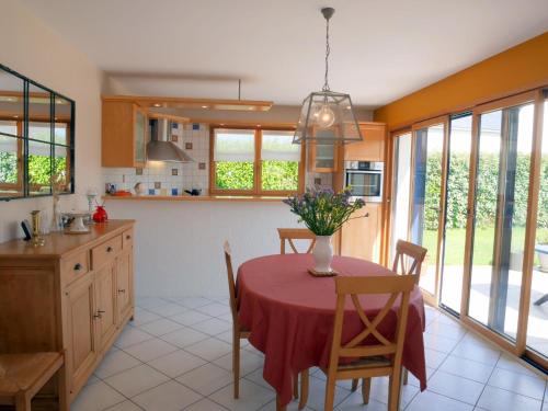 une cuisine avec une table avec un vase de fleurs dessus dans l'établissement Holiday Home in Plouneour near Sandy Beach, à Brignogan-Plage