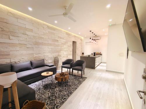 a living room with a blue couch and chairs at 1st Luxury Warehouse in Cancún