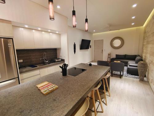 a kitchen and living room with a large counter top at 1st Luxury Warehouse in Cancún