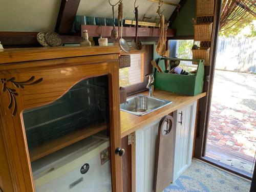 a kitchen with a sink and a counter top at Gypsy Van Tiny House with Unique Outdoor Bathroom, WIFI & Firepit in Coodanup