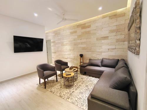 a living room with a couch and two chairs at 1st Luxury Warehouse in Cancún