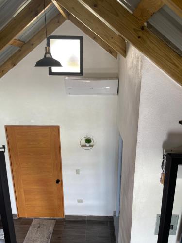 a room with a wooden door and a ceiling at Lovely tiny studio in Jarabacoa