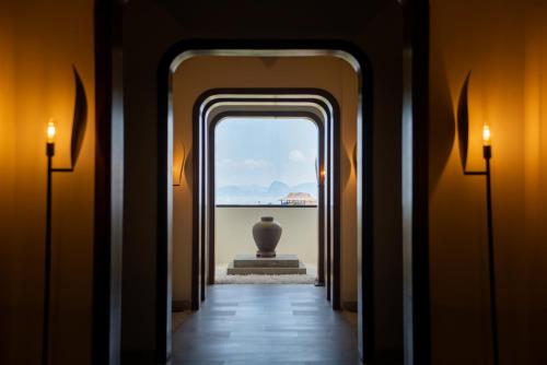 a hallway with a view of a vase in the distance at Hotel Soleil Ha Long, Trademark Collection by Wyndham in Ha Long