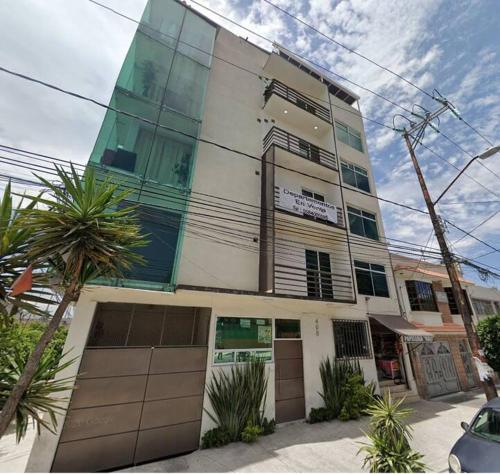 a building with two garage doors in front of it at Private Penthouse / Penthouse Privado in Mexico City