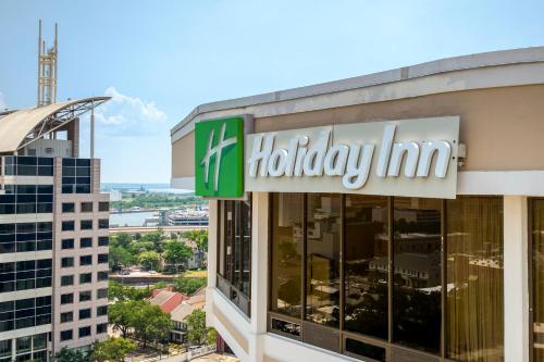 a holiday inn sign in front of a building at Holiday Inn Mobile Downtown Historic District, an IHG Hotel in Mobile