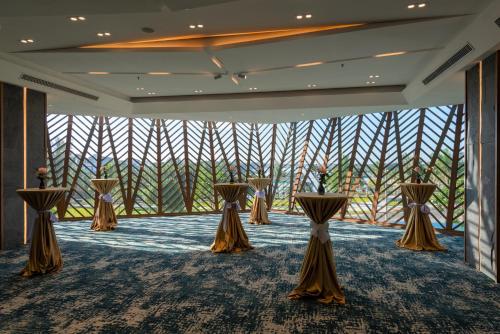 a room with a row of tables with brown skirts at Bellerive Hoi An Resort and Spa in Hoi An