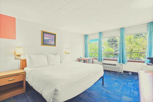 Ένα ή περισσότερα κρεβάτια σε δωμάτιο στο Stardust Motel Wallace