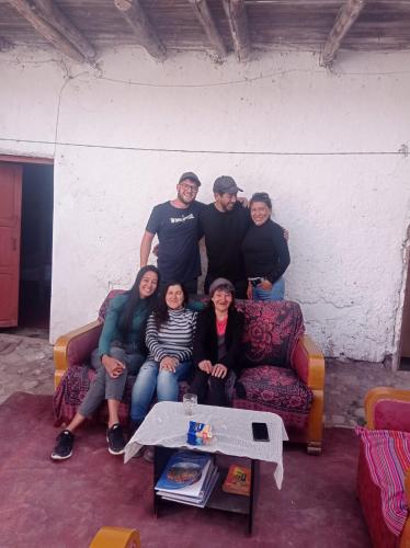 a group of people sitting on a couch at CHINA SAQRA in Cusco