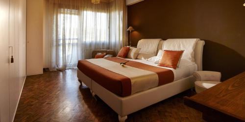 a bedroom with a large bed and a couch at La Dimora Del Bassotto in San Giuliano Terme