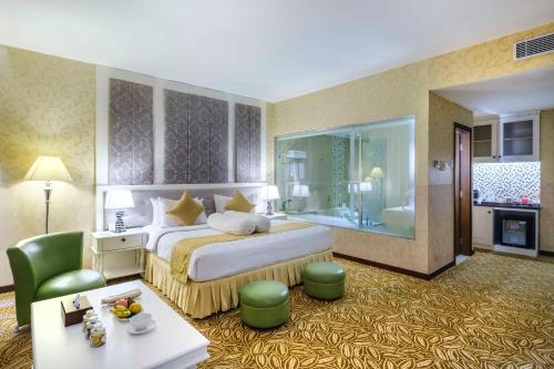 a hotel room with a bed and a bathroom at Grand Artos Hotel & Convention in Magelang