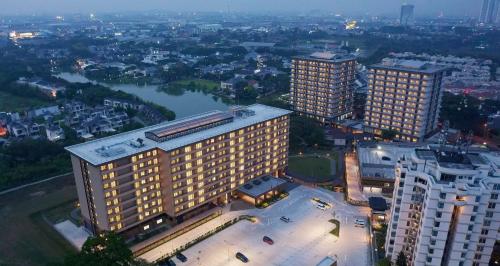 an overhead view of a large building with a city at Axia South Cikarang Service Apartment in Cikarang